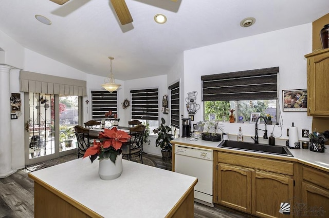 kitchen featuring sink, hanging light fixtures, a center island, white dishwasher, and vaulted ceiling