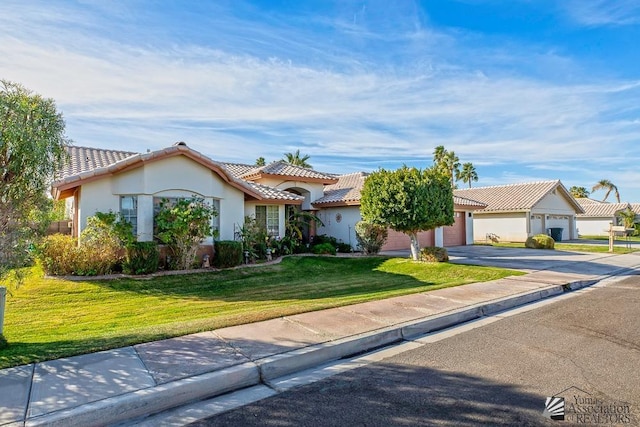 view of front of house with a garage and a front lawn