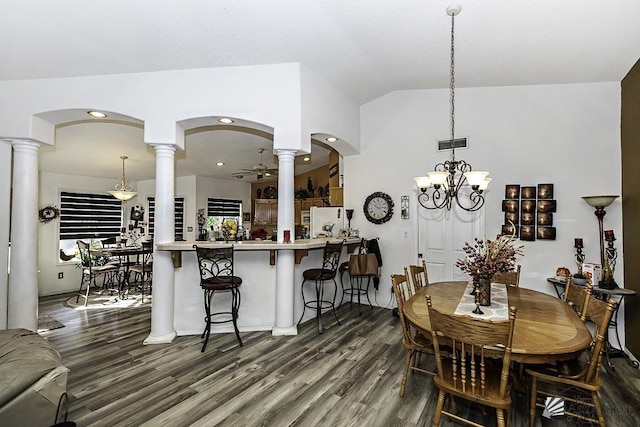 dining area with lofted ceiling, dark wood-type flooring, ceiling fan, and ornate columns