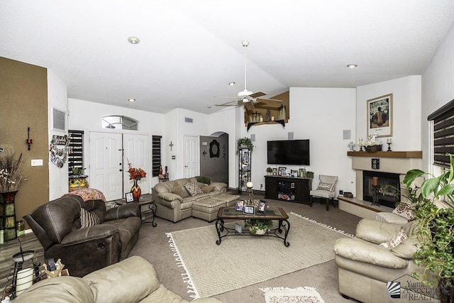 carpeted living room featuring ceiling fan and vaulted ceiling