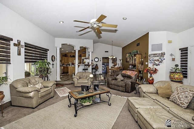 living room featuring ornate columns, lofted ceiling, ceiling fan with notable chandelier, and carpet