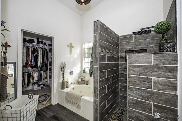 bathroom with independent shower and bath and hardwood / wood-style floors