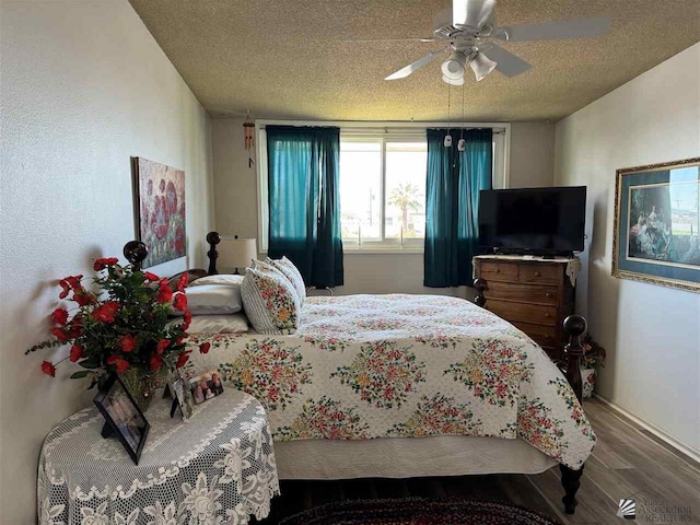 bedroom featuring ceiling fan, a textured ceiling, and wood finished floors