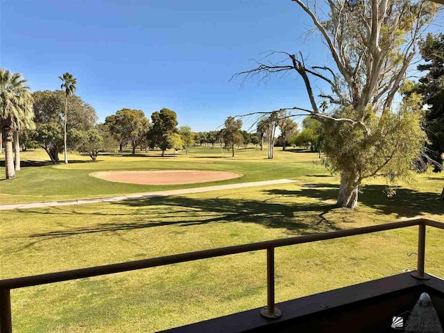 view of community featuring a lawn and golf course view