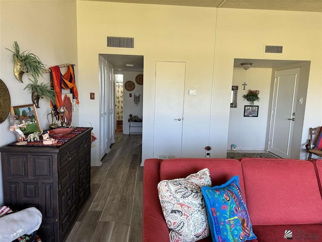 living area with dark wood finished floors and visible vents