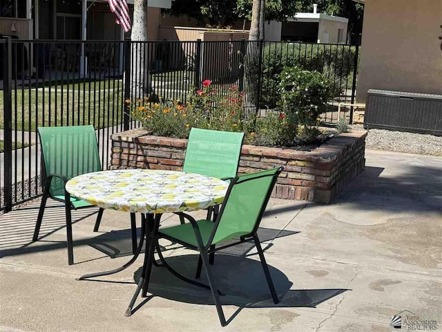 view of patio with fence and outdoor dining space