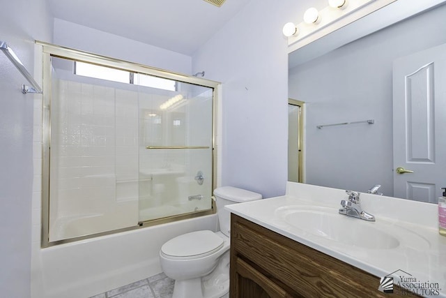 full bathroom featuring enclosed tub / shower combo, vanity, toilet, and tile patterned floors