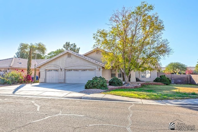 view of front of property with a garage and a front yard