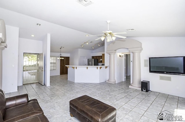 living room with ornate columns, lofted ceiling, light tile patterned floors, and ceiling fan