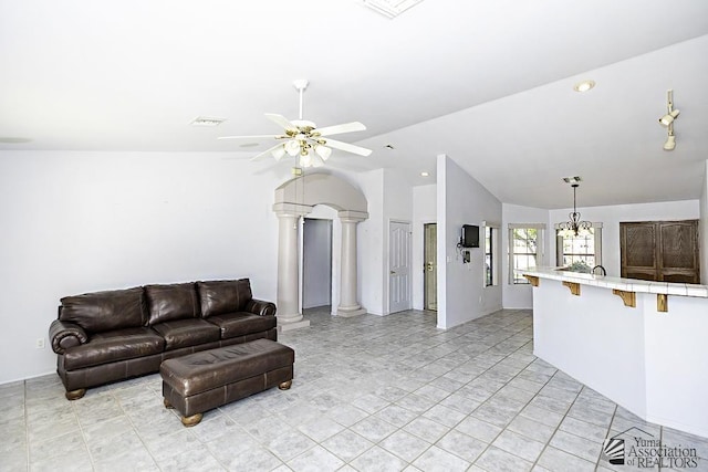 tiled living room with ornate columns, lofted ceiling, and ceiling fan