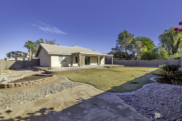 back of property with a patio and a yard