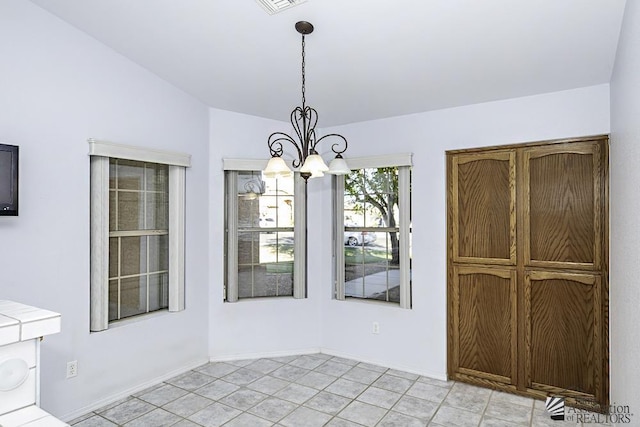 unfurnished dining area with vaulted ceiling and an inviting chandelier