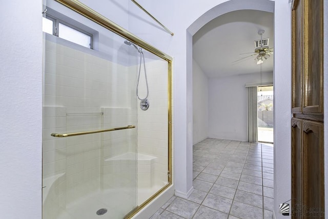 bathroom with ceiling fan, an enclosed shower, and tile patterned floors