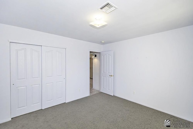 unfurnished bedroom featuring a closet and carpet flooring