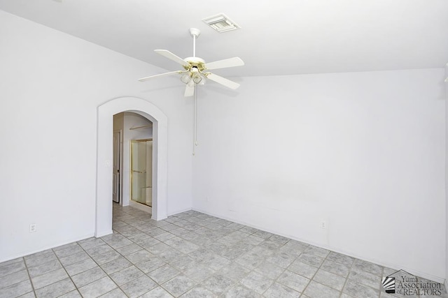 empty room featuring ceiling fan and lofted ceiling