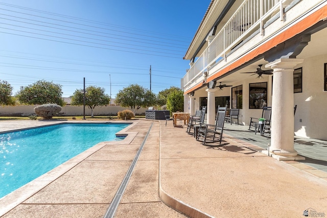 view of swimming pool featuring a patio and ceiling fan