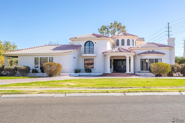 mediterranean / spanish home with a front lawn