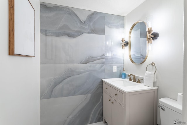 bathroom featuring toilet and vanity