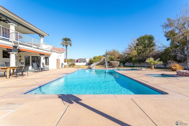 view of swimming pool featuring a patio and a water slide