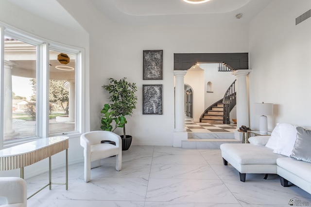 living area with decorative columns