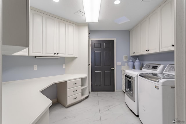 laundry room featuring cabinets and separate washer and dryer