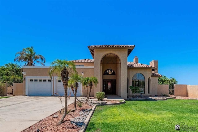 mediterranean / spanish-style house with a garage and a front lawn