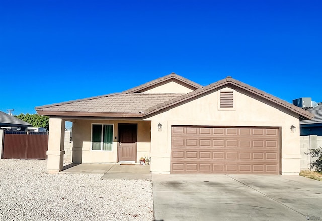 ranch-style house with central AC and a garage