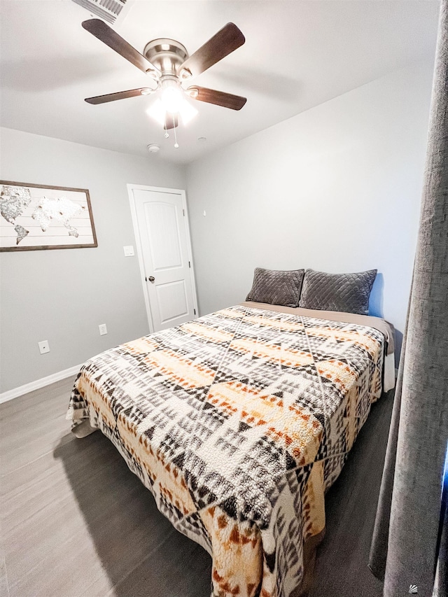 bedroom featuring ceiling fan and dark wood-type flooring