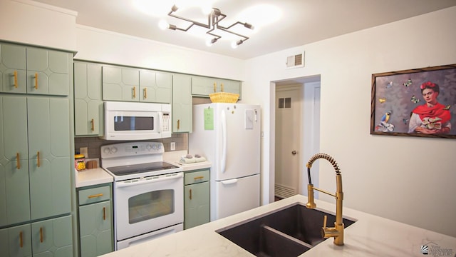 kitchen featuring backsplash, sink, white appliances, and green cabinetry