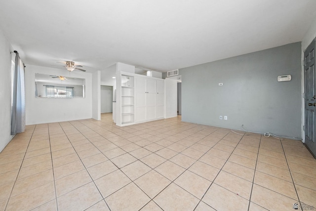 unfurnished living room with a ceiling fan, visible vents, and light tile patterned floors