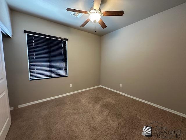 carpeted empty room with ceiling fan