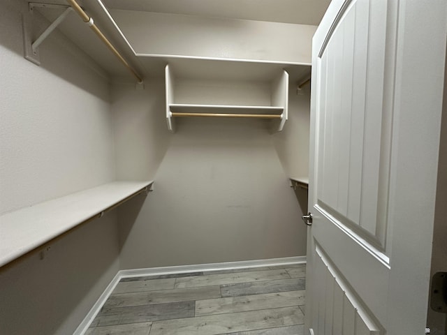 walk in closet featuring light hardwood / wood-style flooring