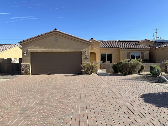 mediterranean / spanish-style home with a garage