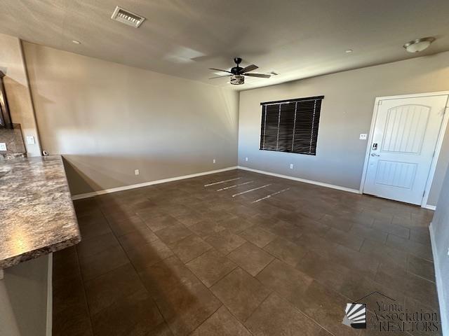 interior space with ceiling fan