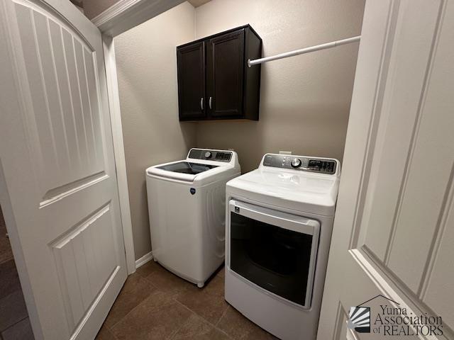 laundry area featuring independent washer and dryer and cabinets