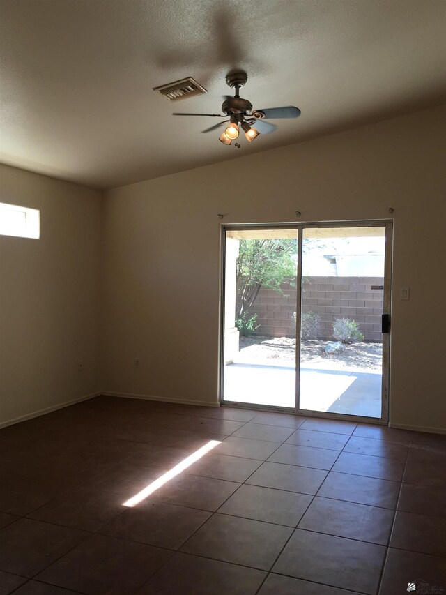 spare room featuring tile patterned floors, ceiling fan, and lofted ceiling