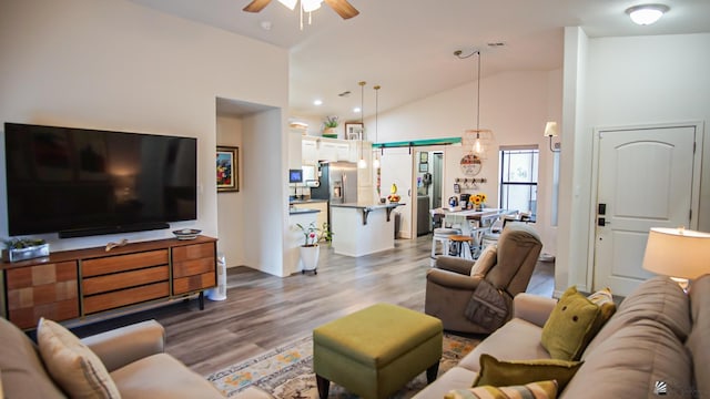 living room featuring hardwood / wood-style flooring, ceiling fan, and lofted ceiling