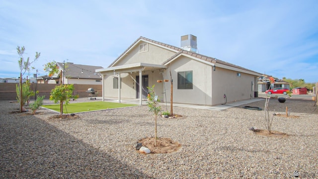 rear view of property featuring a patio area