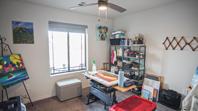 carpeted home office featuring ceiling fan