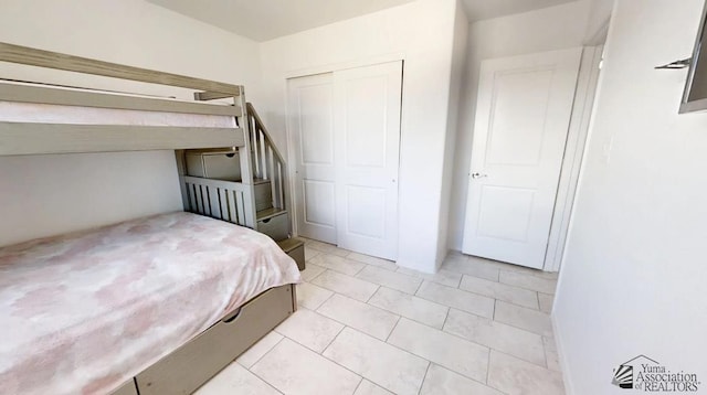 bedroom with a closet and light tile patterned floors