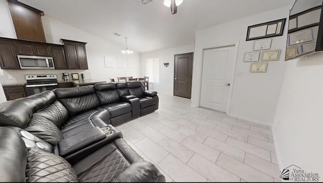 living area featuring visible vents, ceiling fan with notable chandelier, and lofted ceiling