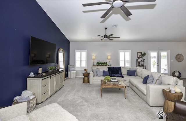 carpeted living room featuring lofted ceiling and french doors