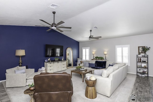 living room featuring hardwood / wood-style flooring, vaulted ceiling, and ceiling fan