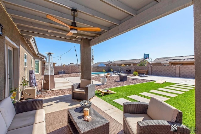 view of patio / terrace featuring ceiling fan, an outdoor hangout area, and a fenced in pool