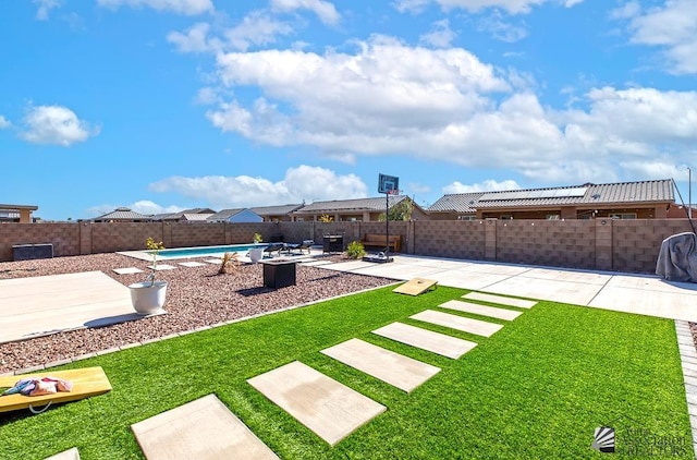 view of yard with a fenced in pool and a patio