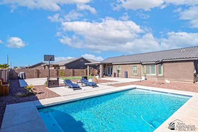 view of swimming pool with a patio