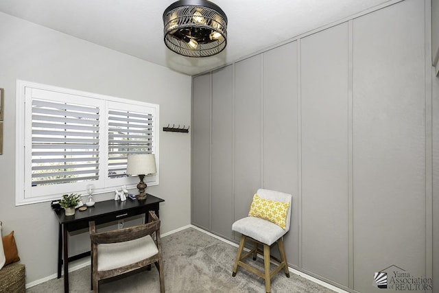 sitting room featuring light colored carpet