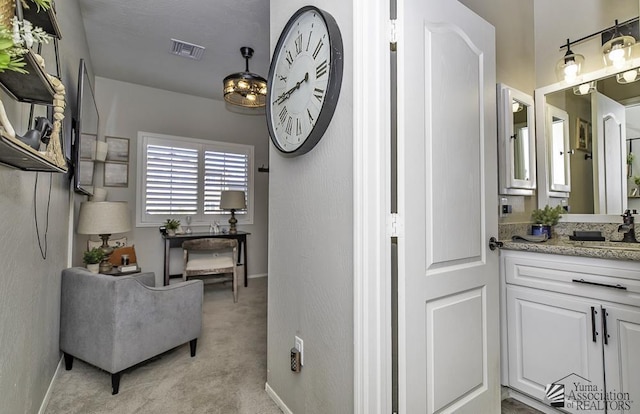 interior space featuring sink and light colored carpet