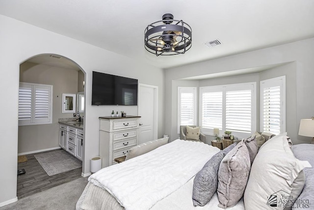 bedroom featuring sink and light carpet