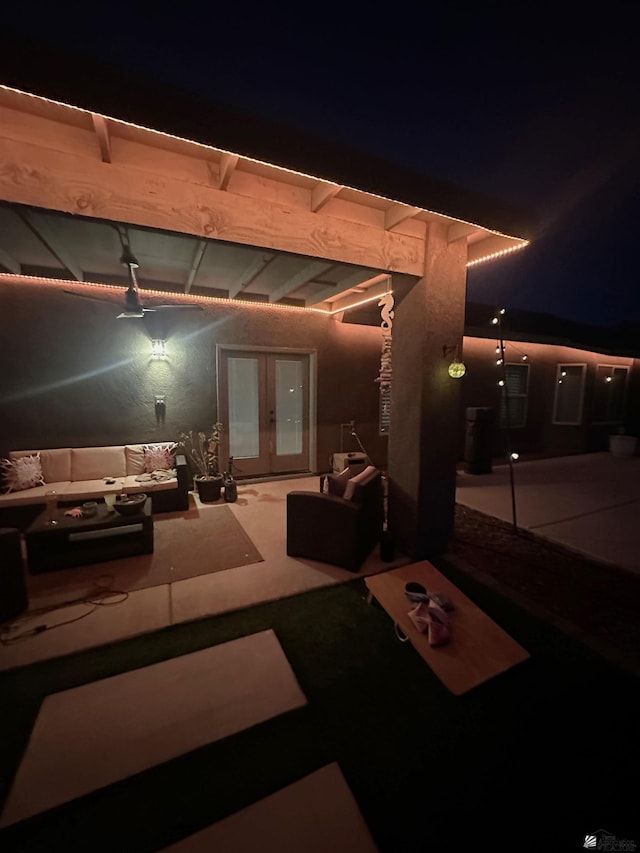 patio at night with outdoor lounge area and french doors